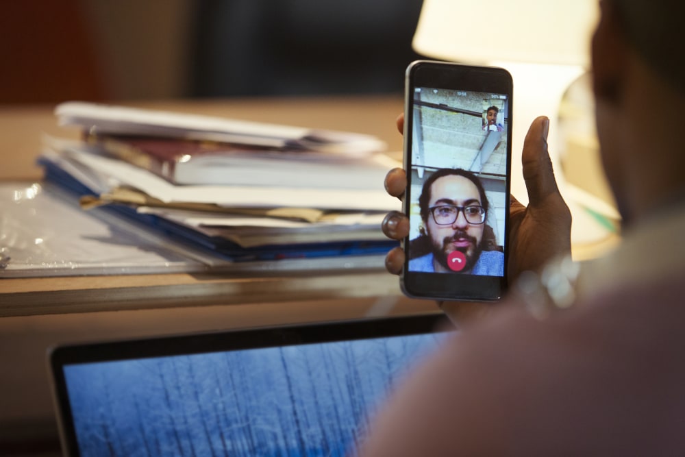 Person holding phone during a video call