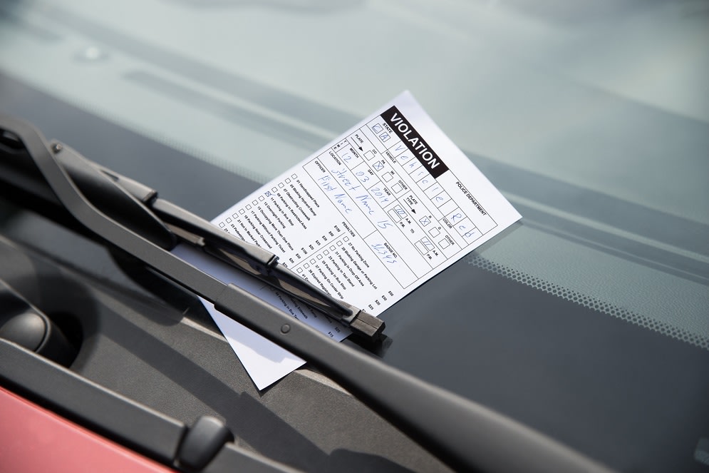 Close-up of parking ticket on car's windshield