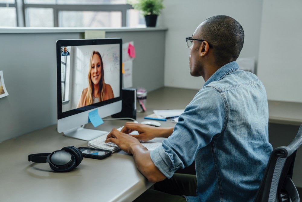 Man having a video conference with a woman on Zoom.