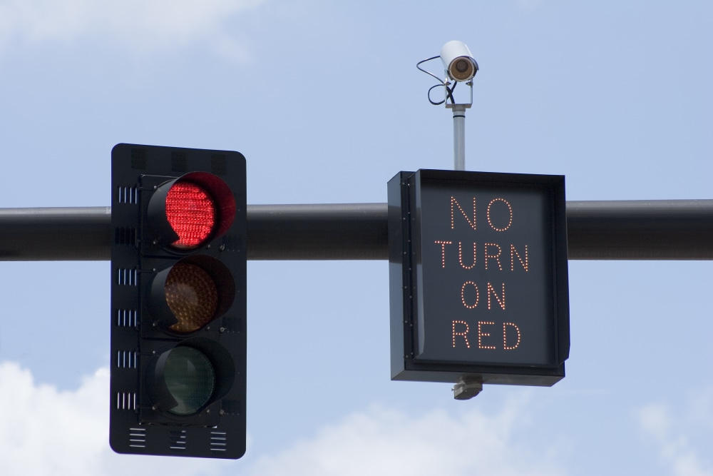 red traffic light next to no turn on red sign