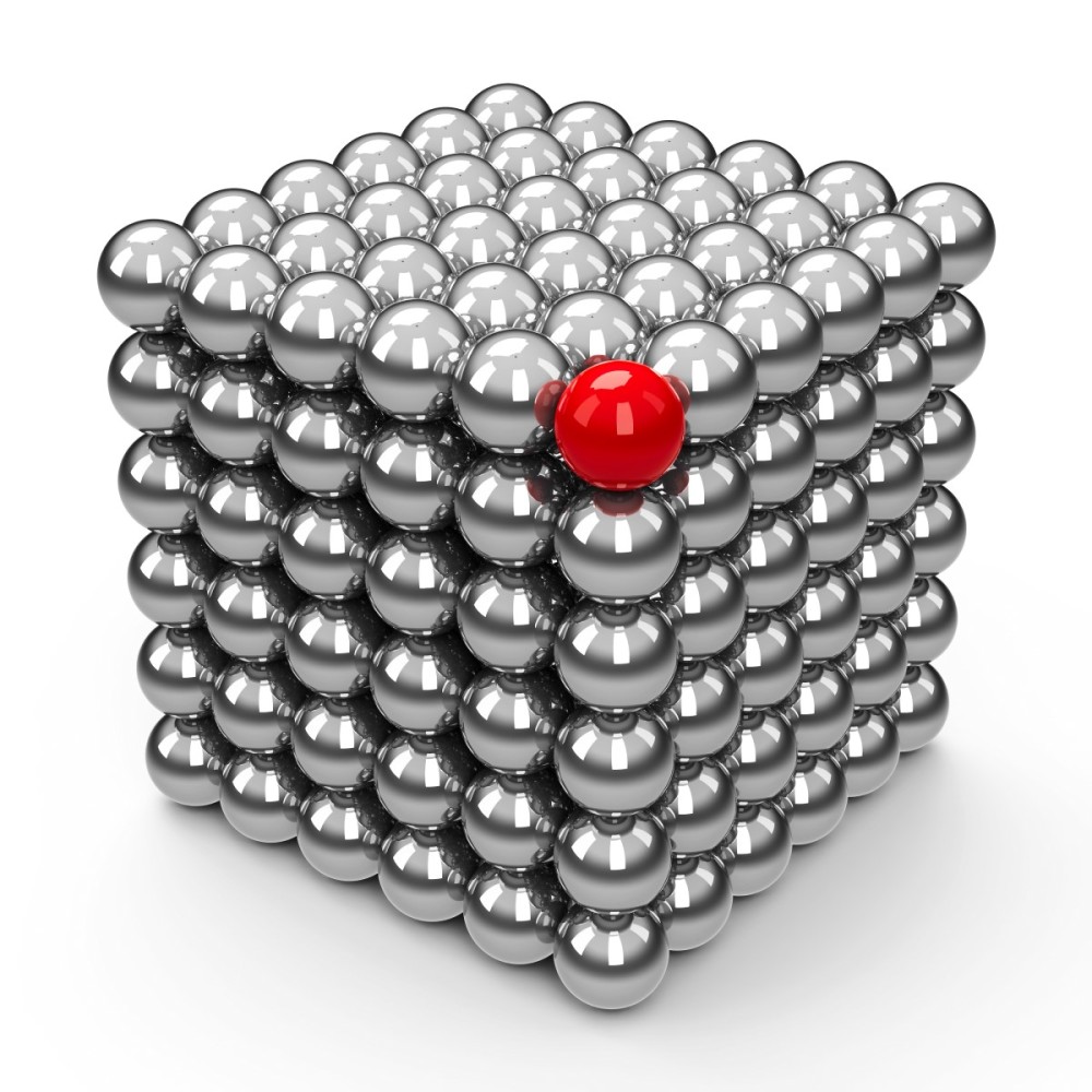 a cube formed by magnetic silver balls, with the top corner colored red
